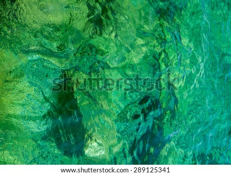 Green, turquoise fresh water background texture. Crystal clear fresh water of Georgian bay of Lake Huron, Canada.