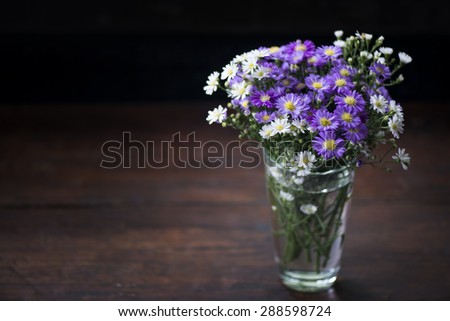 White and Purple Cutter Flowers in glass on the table
