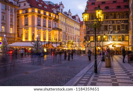 Prague Christmas market on the night in Old Town Square with blurred people on the move. Prague, Czech Republic.
