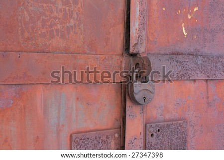 Rusty iron gates locked on old lock