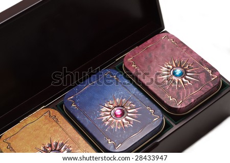 Box with tea, iron packing, decorated stone on white background