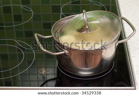 Saucepan with boiling food stand on ceramic lash