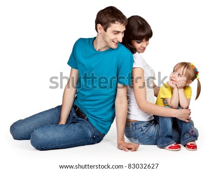 father, mother and young daughter in jeans at the studio on a white background