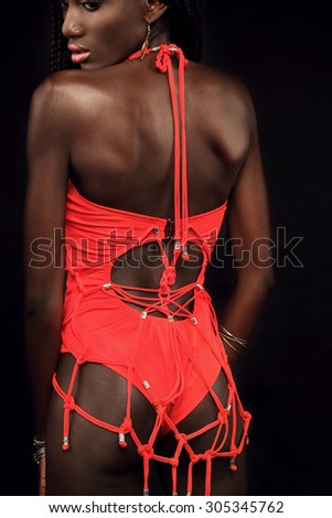 Portrait of sensual african model back in red swimsuit handmade