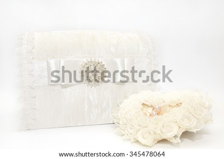 Lace wedding accessories. Wedding rings on a white satin pillow. Wedding gift box. Wedding decoration.