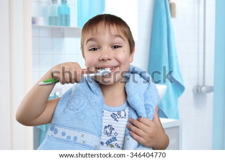 Close up portrait of cute little boy holding toothbrush ready to brush teeth. Morning routine of washing the teeth. Handsome young man is brushing teeth with toothbrush.