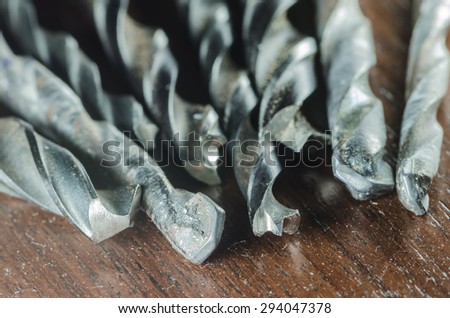 Group of drill bit on wood board
