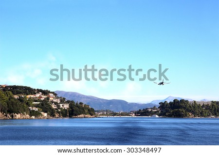 Sea view. Mountain view. Town view. Beautiful Ionian dark blue sea. Sky and sea. Beauty in nature. Corfu. Kerkyra. Greece island. The plane coming in to land