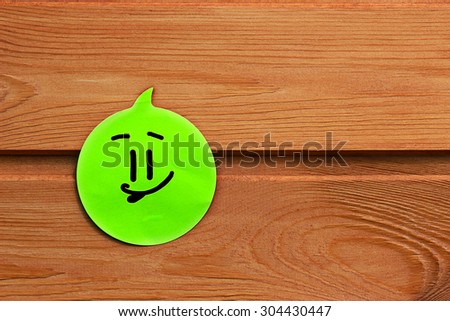 Positive emotion on green sticker on wooden background. Be positive, dont worry. Everything will be ok