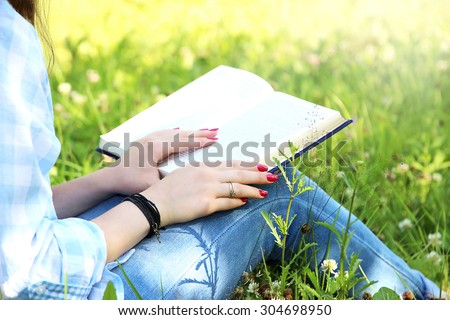 Young girl with book in the green garden. Free happy woman. Knowledge is power. Thirst for knowledge. Book in woman hands