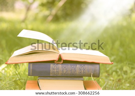 Open book on nature background. Knowledge is power. Flowers in book. Education. Enlightenment