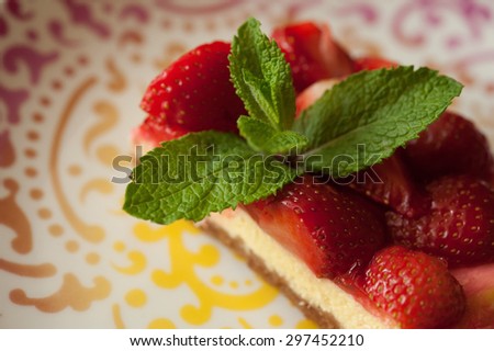 cheesecake with strawberries and mint on plate color