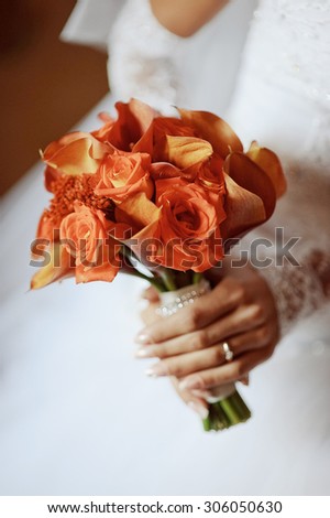 beautiful wedding bouquet of flowers in the hands of the bride