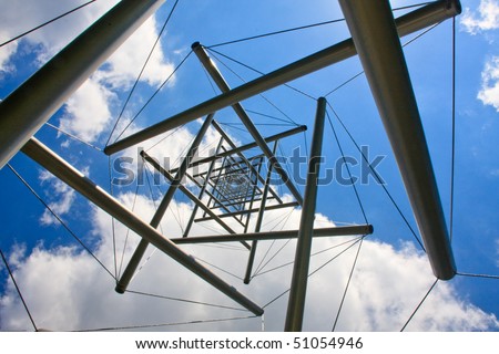A stainless steel and cable tower structured photographer from below