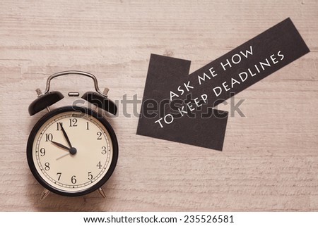 alarm clock and sign saying to ask how to keep deadlines