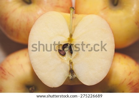 four yellow apples with half apple in the middle.closeup, selective focus