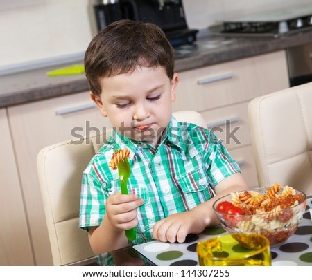 Little boy who does not eat his food with lust