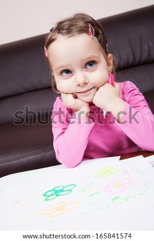 Little preschool girl learn to draw with pencils