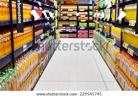BUCHAREST, ROMANIA - OCTOBER 22, 2014: Bottles of juice on supermarket stand