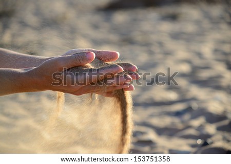 sand pours out of the hands
