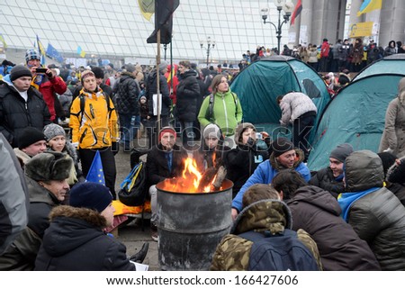 KIEV, UKRAINE - DECEMBER 08: Mass meeting of millions for the government's resignation, protesters are heated by the fire, December 08, 2013,  Independence Square (Maydan) in Kiev