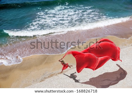 woman with a red tissue on the beach