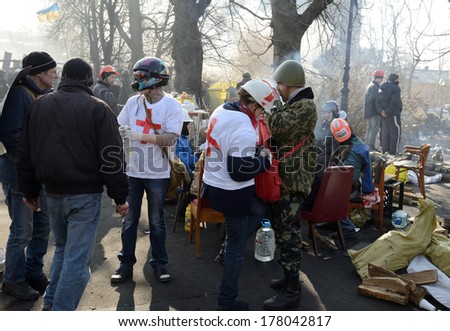 KIEV, UKRAINE - February 21, 2014: Ukrainian revolution, Euromaidan. Medical volunteers helps soldiers