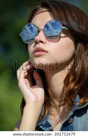 young woman in mirrored sunglasses