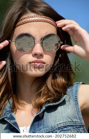 young woman in mirrored sunglasses