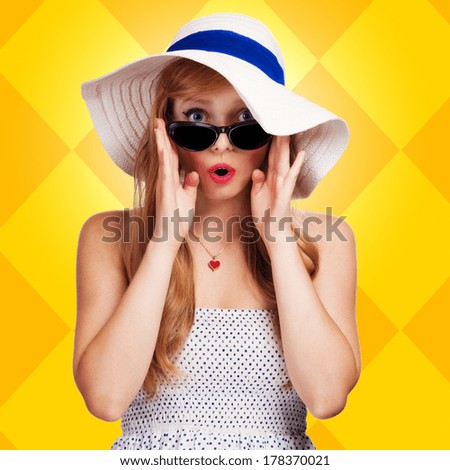 portrait of a girl in a hat on a yellow background