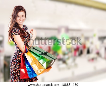 Beauty Woman with Shopping Bags in Shopping Mall.
