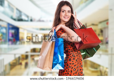 Beauty Woman with Shopping Bags in Shopping Mall.