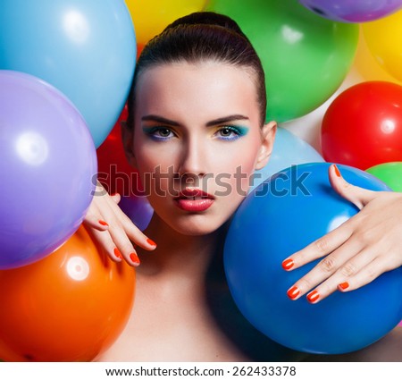 Beauty Girl Portrait with Colorful Makeup, Nail polish and Accessories. Colourful Studio Shot of Funny Woman. Vivid Colors.