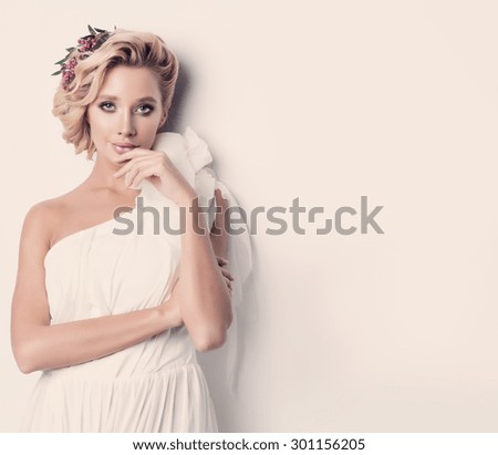Beauty woman with wedding hairstyle and makeup. Bride fashion. Jewelry and Beauty. Woman in white dress,perfect skin, blond hair. Girl with stylish haircut. .Wedding decoration. Bride with flowers