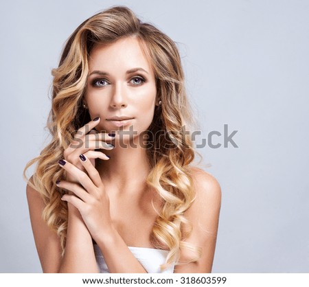Portrait of beautiful blonde woman with curly hairstyle and bright makeup.  Natural look. studio, isolated.