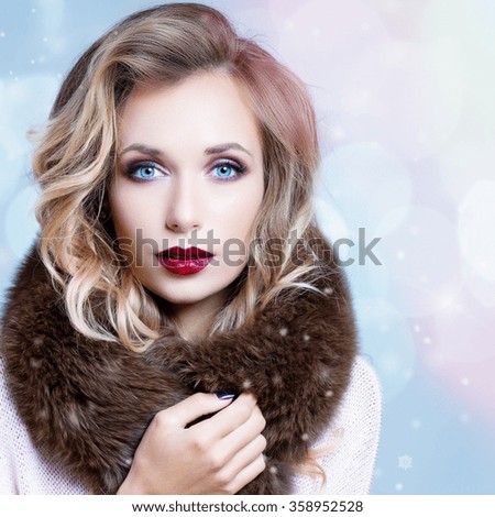 Winter Woman in Luxury Fur Coat. Beauty Fashion Model Girl in Blue Fox Fur Coat. Perfect Makeup, accessories and hairstyle. Beautiful Luxury Winter Lady