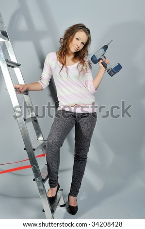 girl with drill on ladder