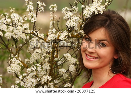 A girl with flowers smiling