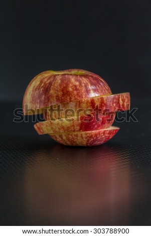 Apple slices on black background.