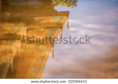 Reflection of the church roof In the flood water