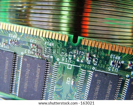 Close up of SIMM memory module against stack of blank cds