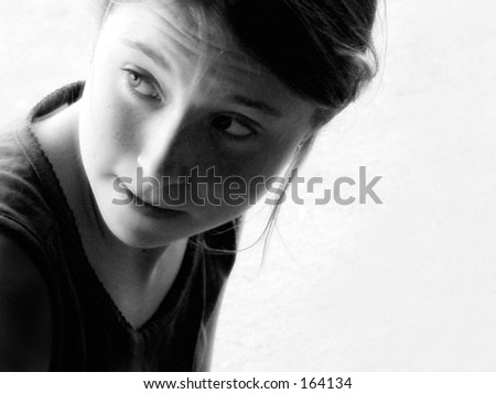 Black and white portrait of young girl looking over shoulder