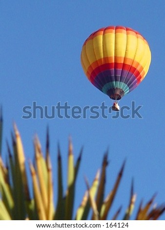 Hot air balloon against blue sky in desert