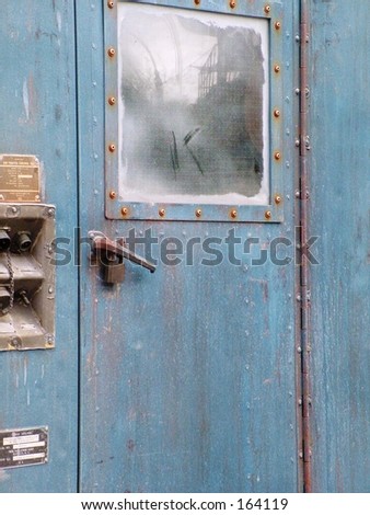 Interesting blue metal door on side of old building
