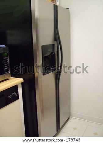Stainless steel refrigerator in small kitchen