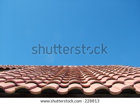 Red Tile Roof Against Bright Blue Sky