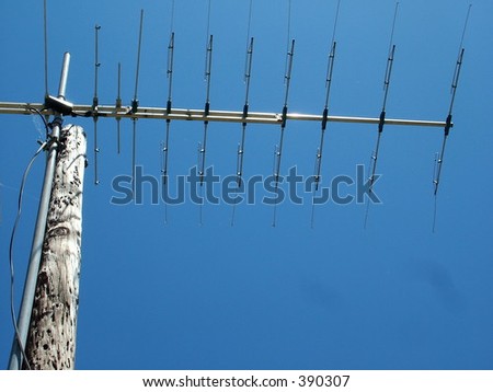 Old TV Antenna against bright blue sky