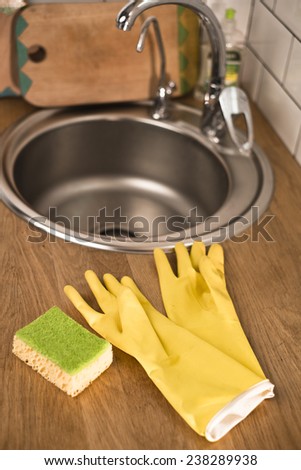 gloves for washing dishes on a wooden background
