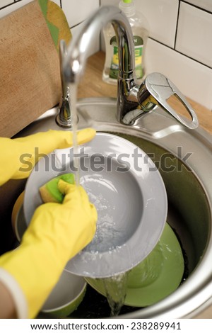 gloves for washing dishes on a wooden background