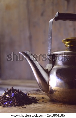 metal tea kettle on wooden background